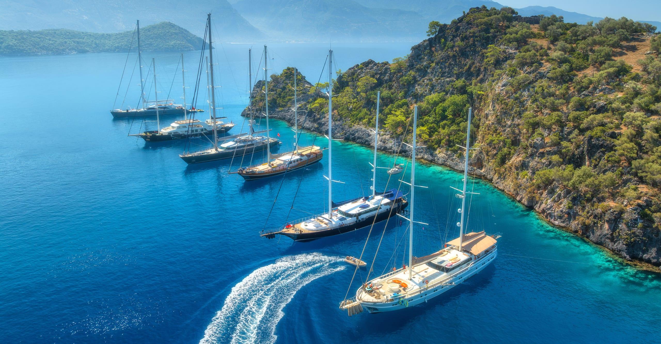 A fleet of yachts moored in a turquoise bay