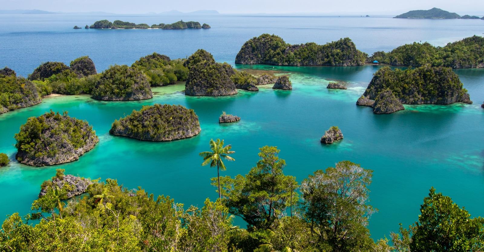 An Indonesian island coastline above a clear lagoon